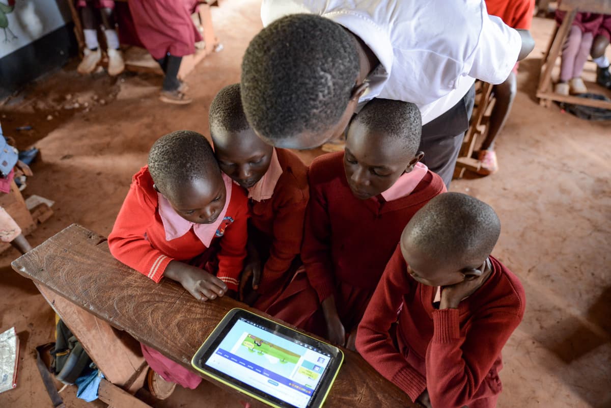 African children learning with digital tablets in classroom